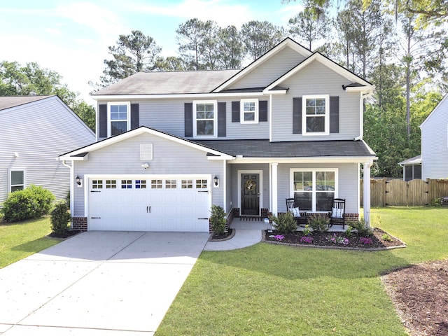 craftsman-style house with covered porch, driveway, a front yard, a garage, and fence