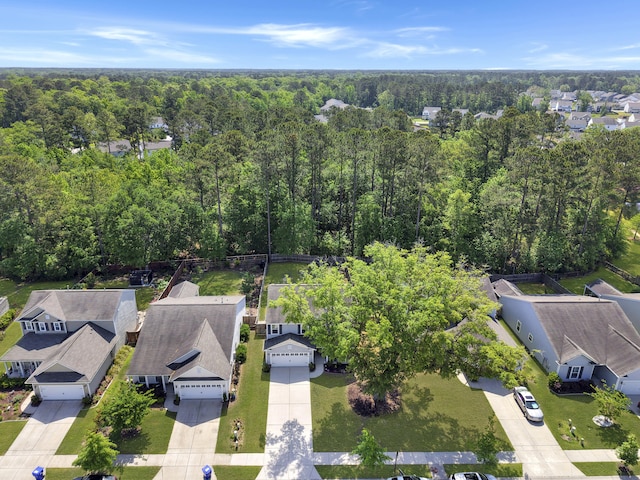 birds eye view of property featuring a wooded view and a residential view