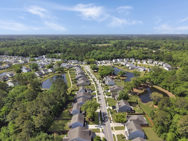 birds eye view of property featuring a view of trees and a residential view
