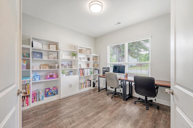home office with visible vents and wood finished floors