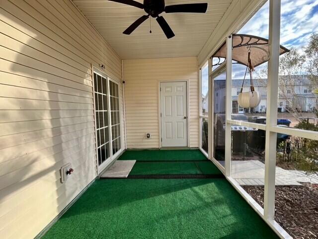 unfurnished sunroom with ceiling fan and wooden ceiling