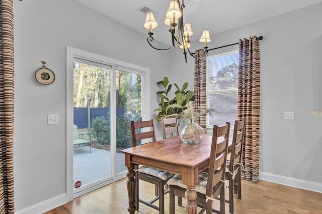 dining room with a notable chandelier and light hardwood / wood-style floors