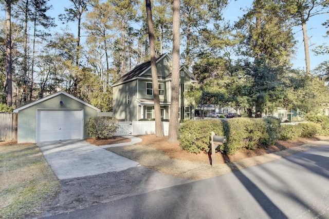 view of front of property with a garage and an outdoor structure