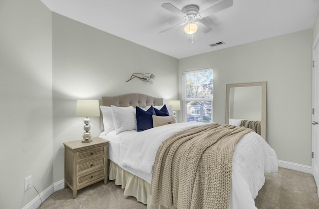 bedroom with ceiling fan and light carpet