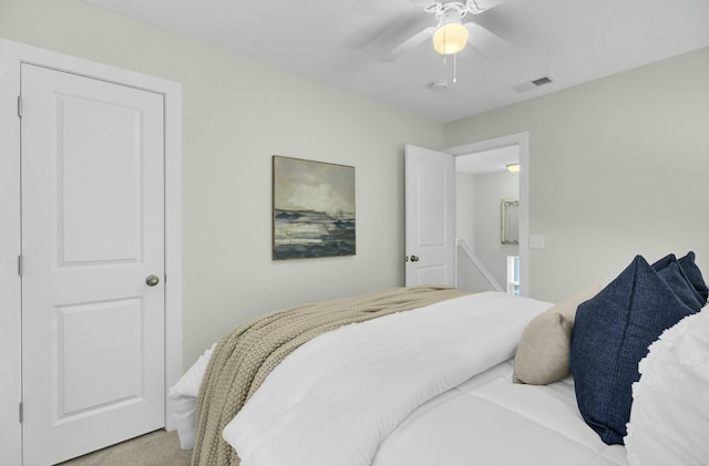 bedroom with ceiling fan and light colored carpet