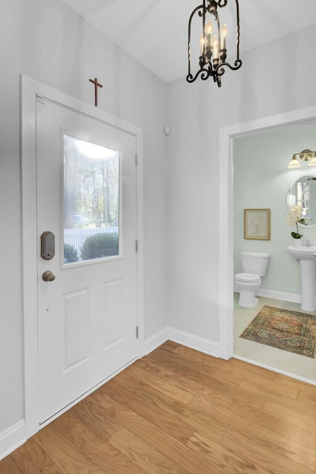 entrance foyer featuring an inviting chandelier and light wood-type flooring