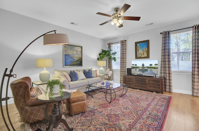 living room featuring light wood-type flooring and ceiling fan