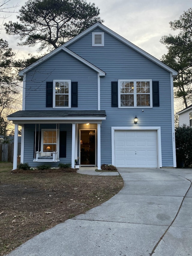 front of property with a garage and covered porch