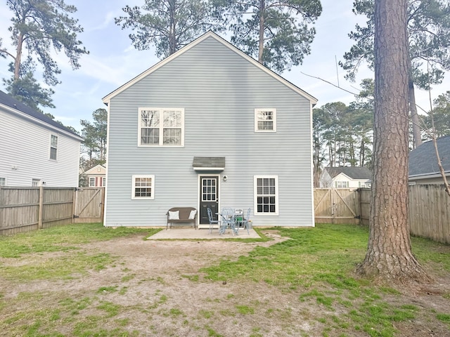 rear view of house featuring a patio and a lawn