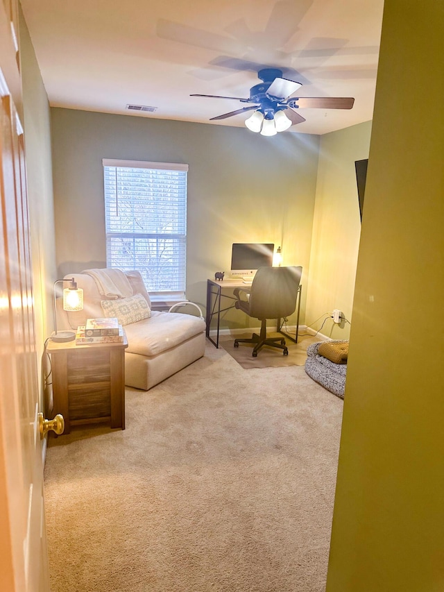 carpeted office space featuring ceiling fan