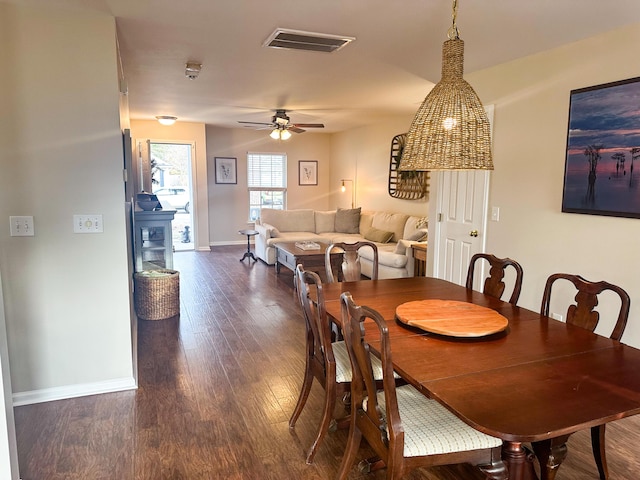 dining space with dark hardwood / wood-style floors and ceiling fan