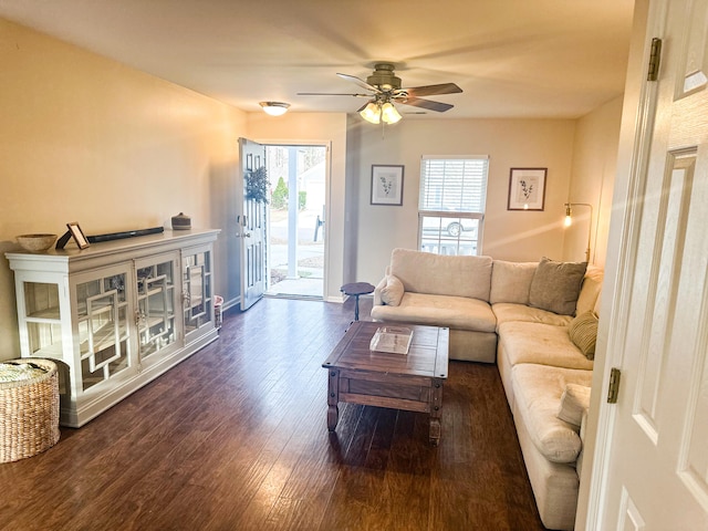 living room featuring dark hardwood / wood-style flooring and ceiling fan