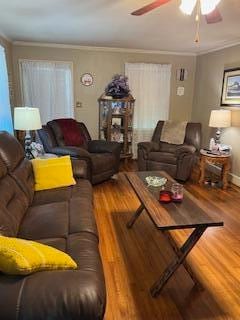 living room with ornamental molding, wood-type flooring, and ceiling fan