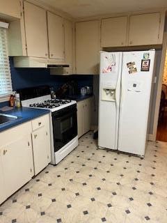 kitchen with white appliances and light tile floors