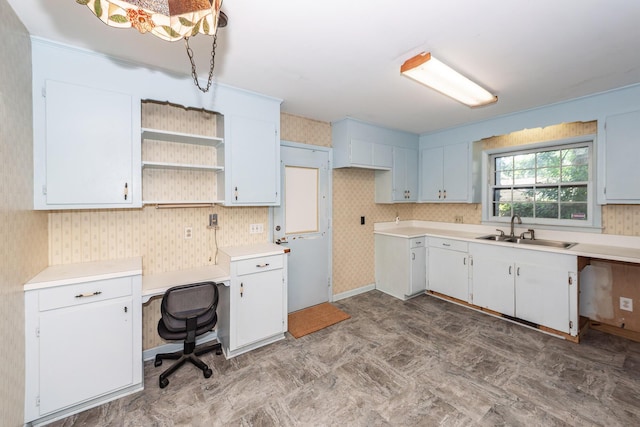 2320 Wofford Rd, Charleston, SC 29414 - kitchen featuring wallpapered walls, light countertops, open shelves, and white cabinetry
