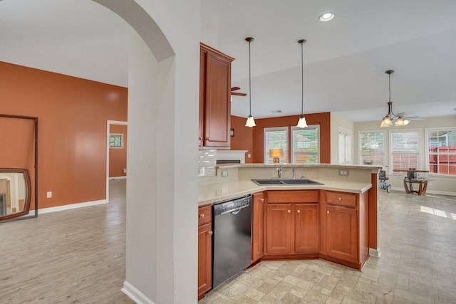 kitchen featuring black dishwasher, backsplash, lofted ceiling, decorative light fixtures, and ceiling fan with notable chandelier