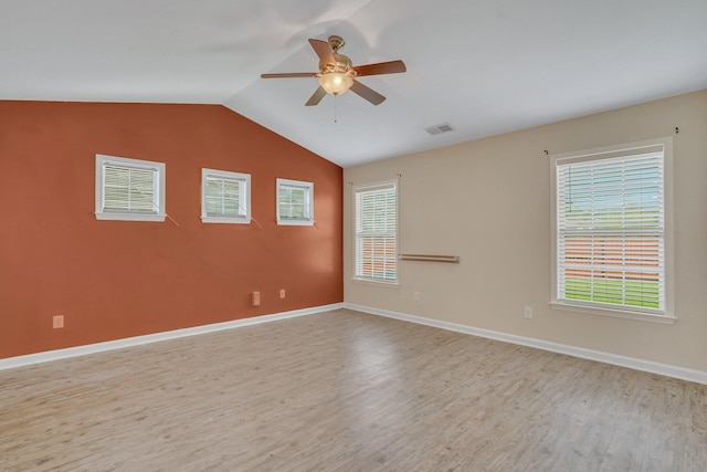 spare room with ceiling fan, light hardwood / wood-style floors, and vaulted ceiling