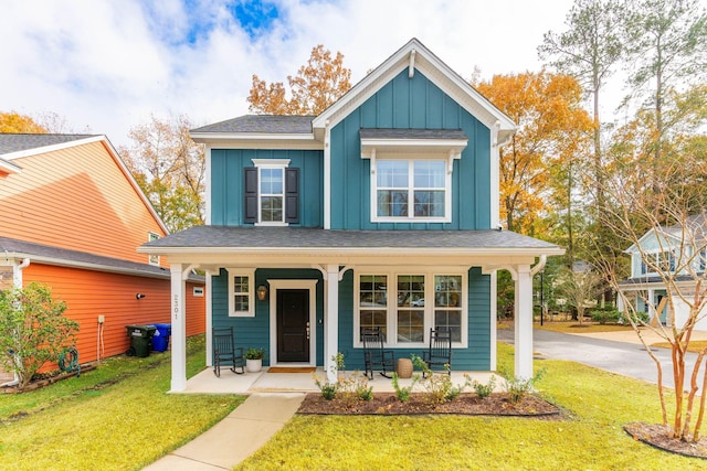 view of front of house with covered porch and a front yard