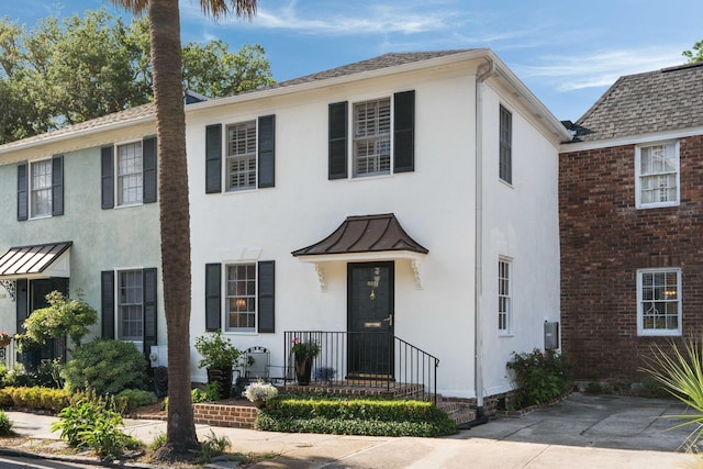 1661/2 Queen St, Charleston, SC 29401 - view of front facade with stucco siding, a standing seam roof, and metal roof
