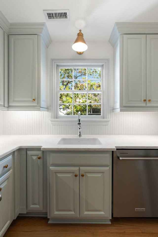 1661/2 Queen St, Charleston, SC 29401 - kitchen featuring stainless steel dishwasher, a sink, light countertops, and wood finished floors