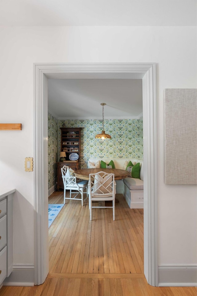 1661/2 Queen St, Charleston, SC 29401 - dining room with wallpapered walls, light wood-style floors, and baseboards