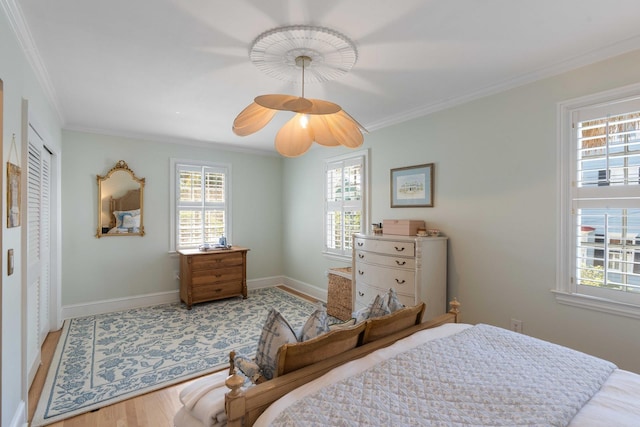 1661/2 Queen St, Charleston, SC 29401 - bedroom with multiple windows, crown molding, wood finished floors, baseboards, and ceiling fan