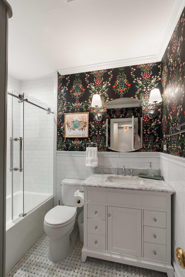 1661/2 Queen St, Charleston, SC 29401 - full bathroom with toilet, wainscoting, vanity, tile walls, and bath / shower combo with glass door