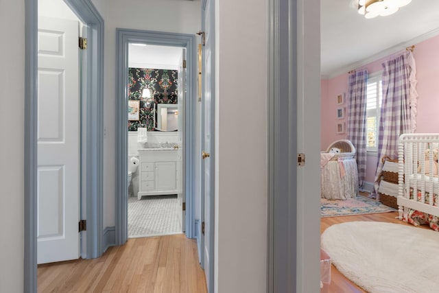 1661/2 Queen St, Charleston, SC 29401 - hallway with light wood-style flooring and ornamental molding