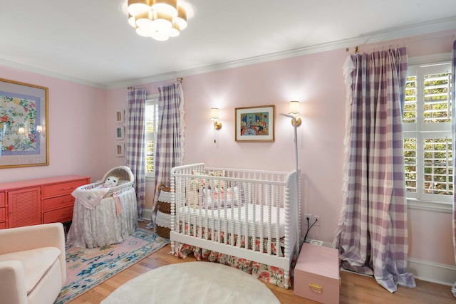 1661/2 Queen St, Charleston, SC 29401 - bedroom featuring wood finished floors, ornamental molding, baseboards, and a chandelier
