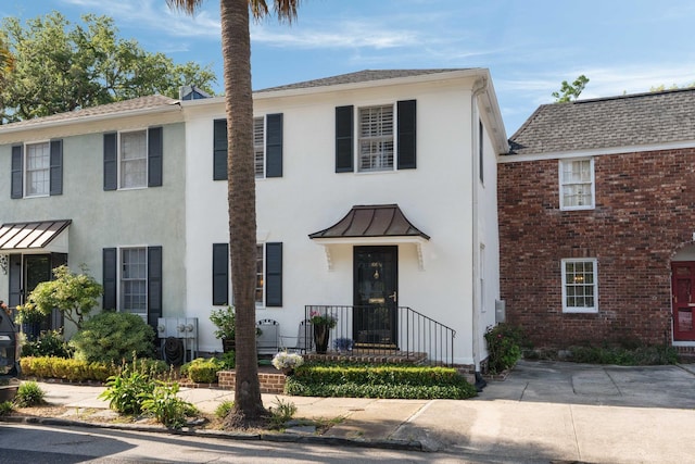 1661/2 Queen St, Charleston, SC 29401 - view of property featuring a standing seam roof, stucco siding, brick siding, and metal roof