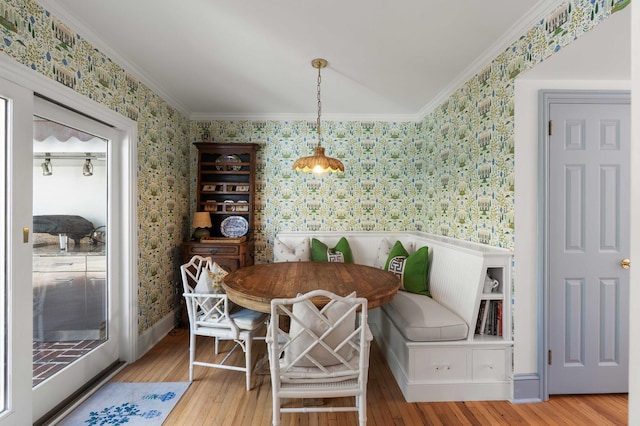 1661/2 Queen St, Charleston, SC 29401 - dining area featuring wallpapered walls, breakfast area, wainscoting, wood finished floors, and ornamental molding