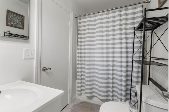 full bathroom with shower / bathtub combination with curtain, toilet, and sink