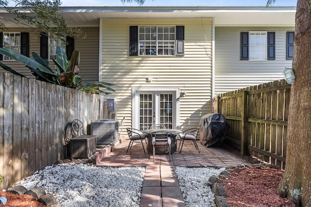 rear view of property featuring cooling unit and a patio area