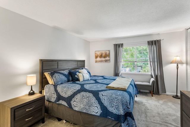 carpeted bedroom featuring a textured ceiling