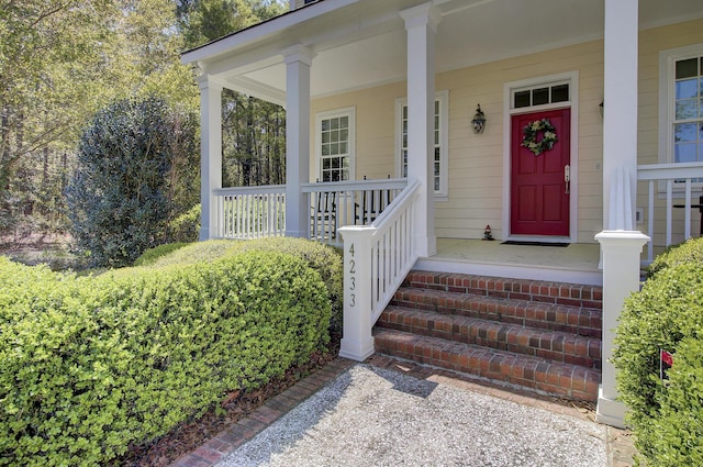 view of exterior entry featuring a porch