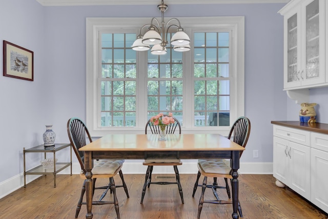 dining room with a chandelier, baseboards, and dark wood-style flooring