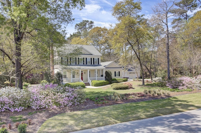 colonial-style house with covered porch and a front lawn