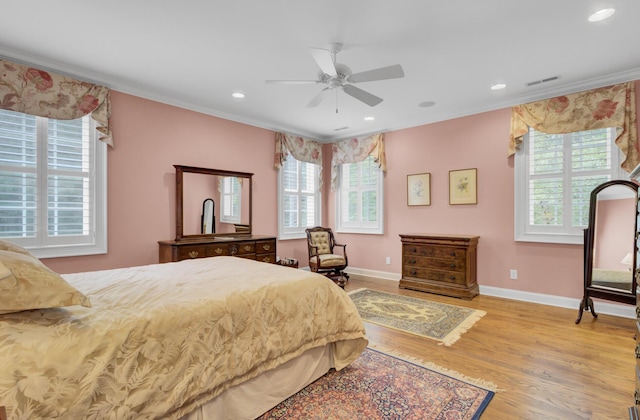 bedroom featuring wood finished floors, crown molding, baseboards, recessed lighting, and a ceiling fan