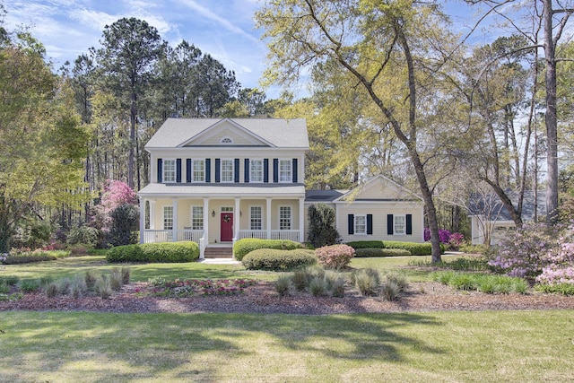 view of front of home with covered porch and a front yard