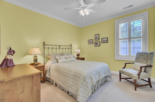 bedroom with light carpet, ornamental molding, baseboards, and a ceiling fan