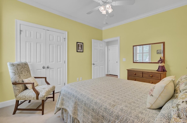 carpeted bedroom featuring a closet, crown molding, a ceiling fan, and baseboards