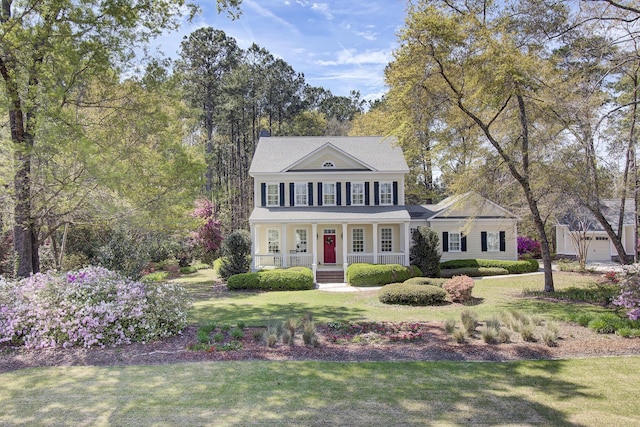 view of front of home with covered porch and a front lawn