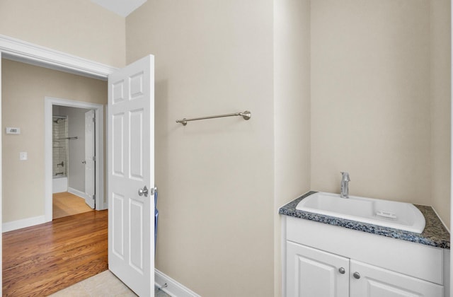 bathroom featuring a sink and baseboards