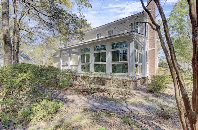 view of side of home with a sunroom