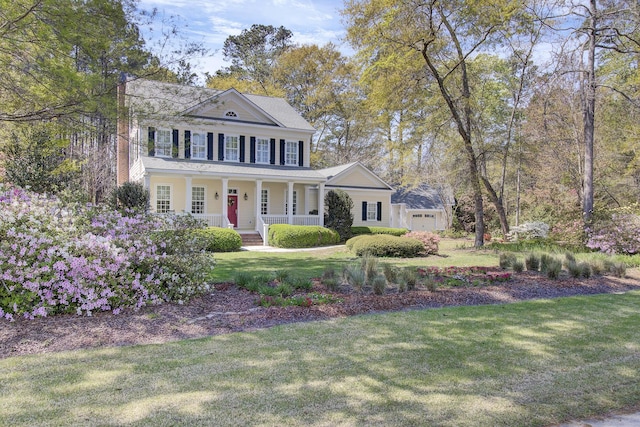 view of front of home featuring covered porch and a front lawn