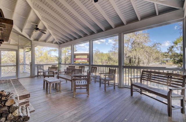 sunroom / solarium featuring ceiling fan
