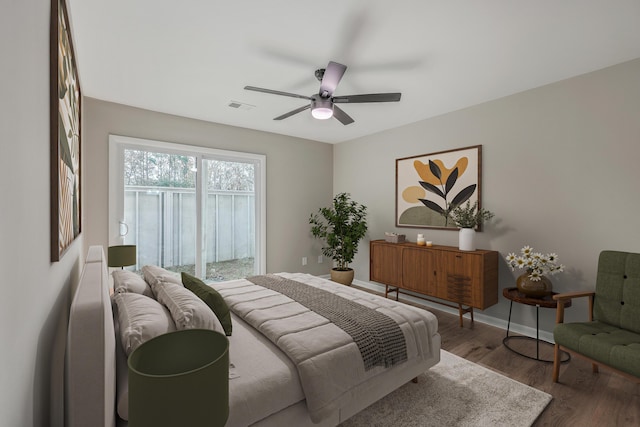 bedroom with ceiling fan and hardwood / wood-style flooring