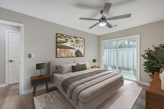 bedroom with ceiling fan, light hardwood / wood-style flooring, and access to outside