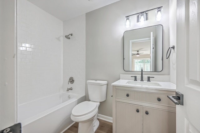 full bathroom with shower / bathtub combination, wood-type flooring, vanity, toilet, and ceiling fan