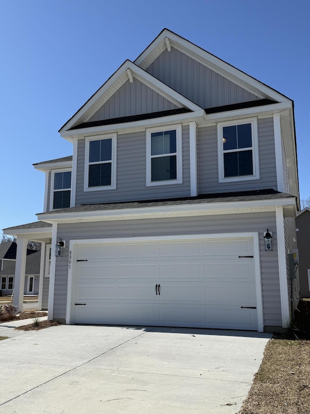 view of front facade with board and batten siding, concrete driveway, and a garage